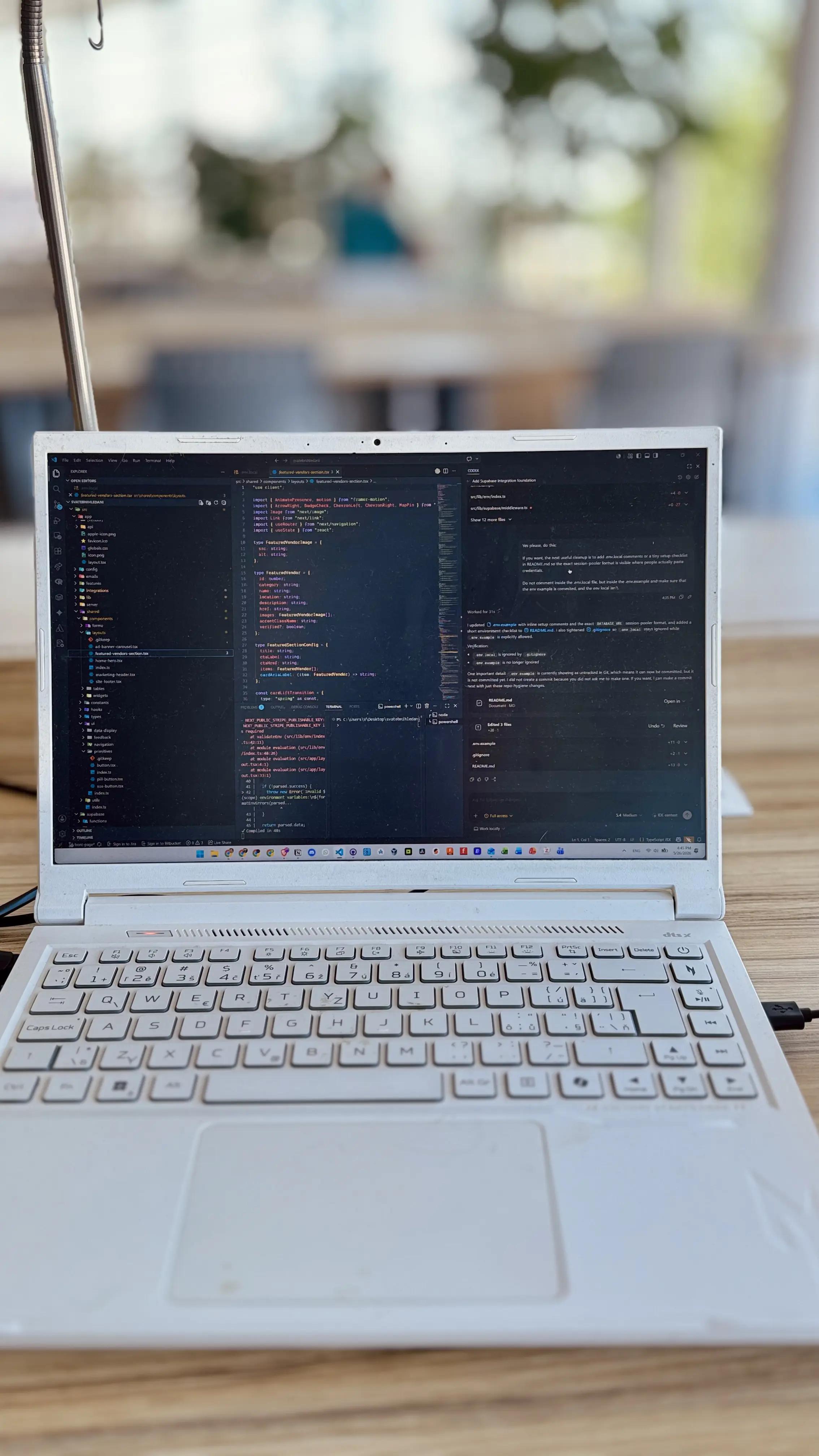 Vojtěch Bobek's workspace with a laptop, monitor, keyboard, and coffee during a development session.